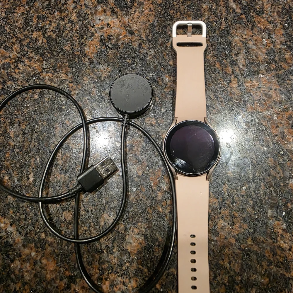 Samsung Smartwatch with Beige Strap and Black Dial